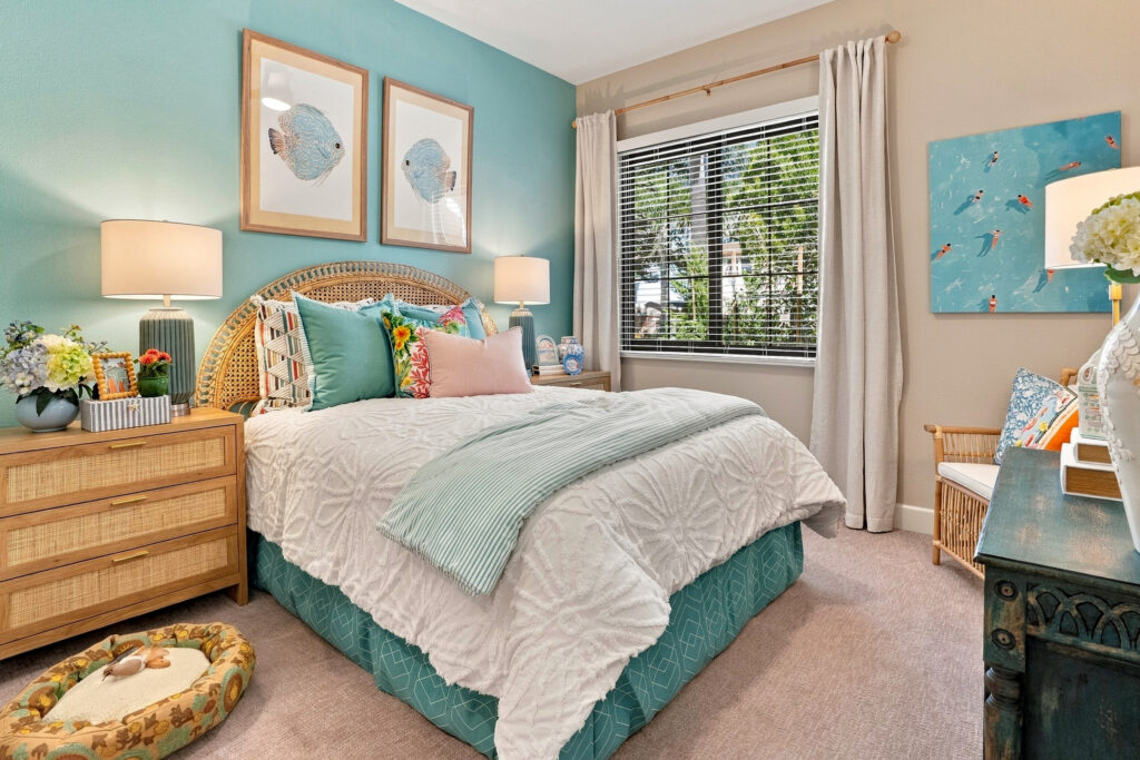 Bedroom space with aqua colors and a window looking outside