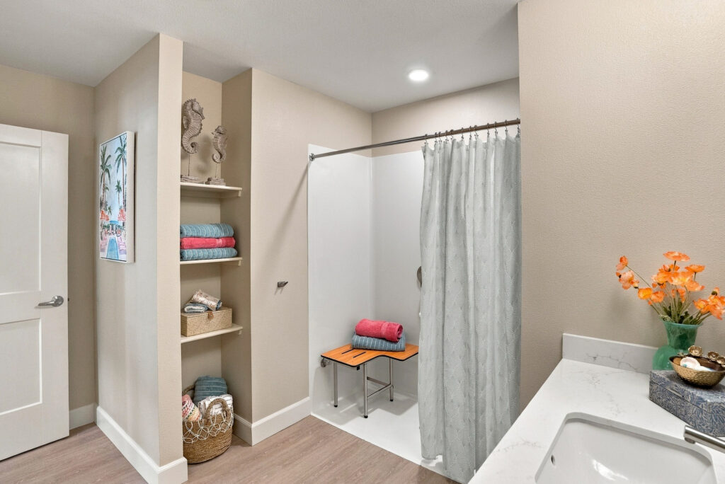 Bathroom space showing a zero-entry shower and colorful accents